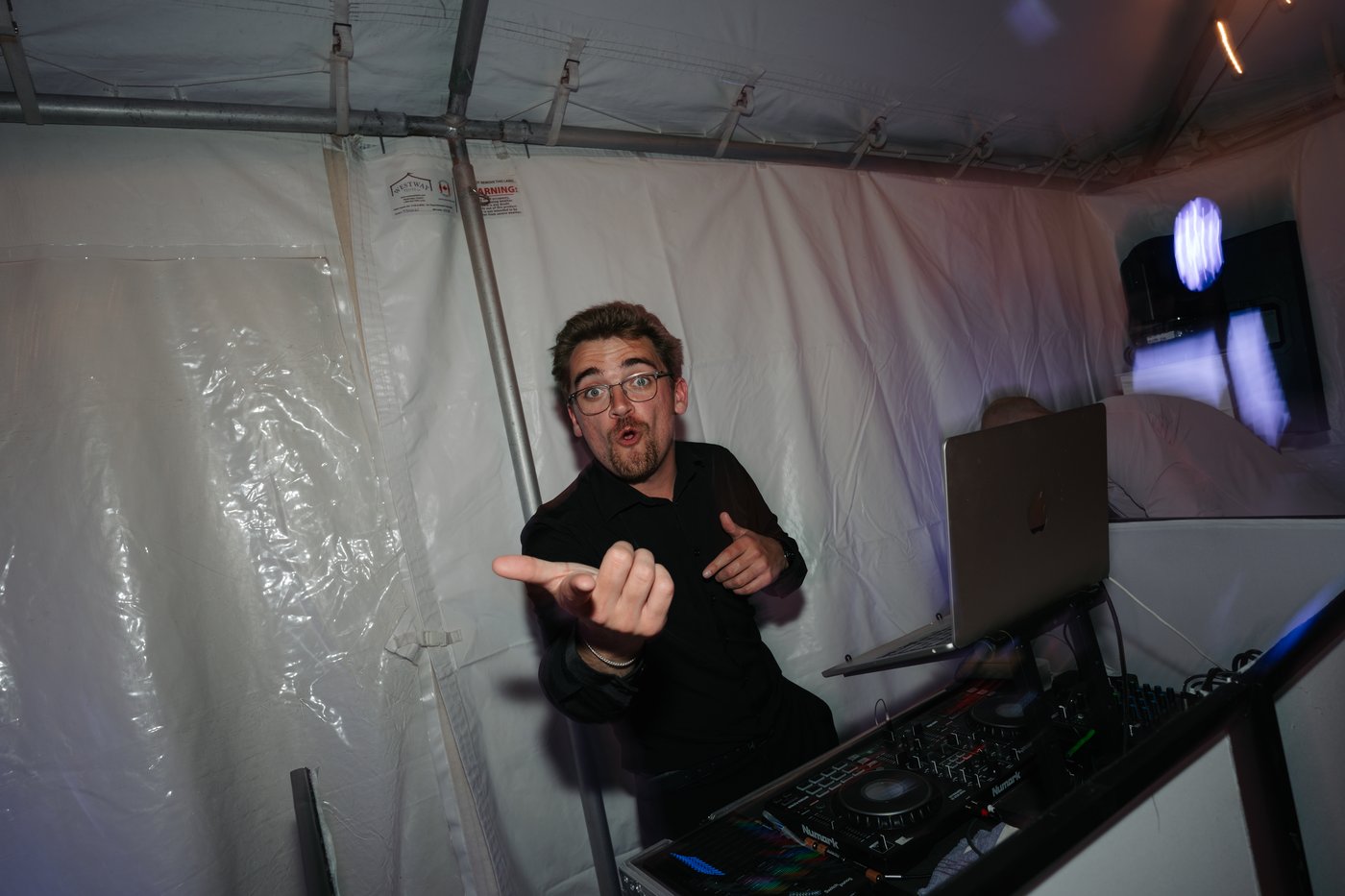 Ryan Dumais behind the DJ booth at a wedding